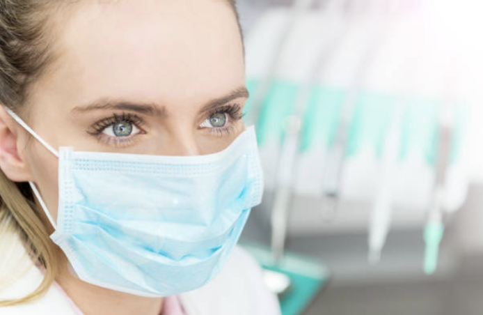 Woman wearing blue surgical mask